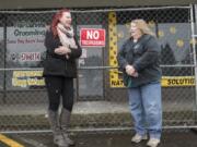 Colleen Conrad, owner of Dog Gone Clean, left, and Connie Skinner, owner of Mind Your Manners Dog Center, revisit the Holly Park Shopping Center. A Jan. 19 fire temporarily closed their businesses, forcing each of them to incur costs and develop recovery plans.