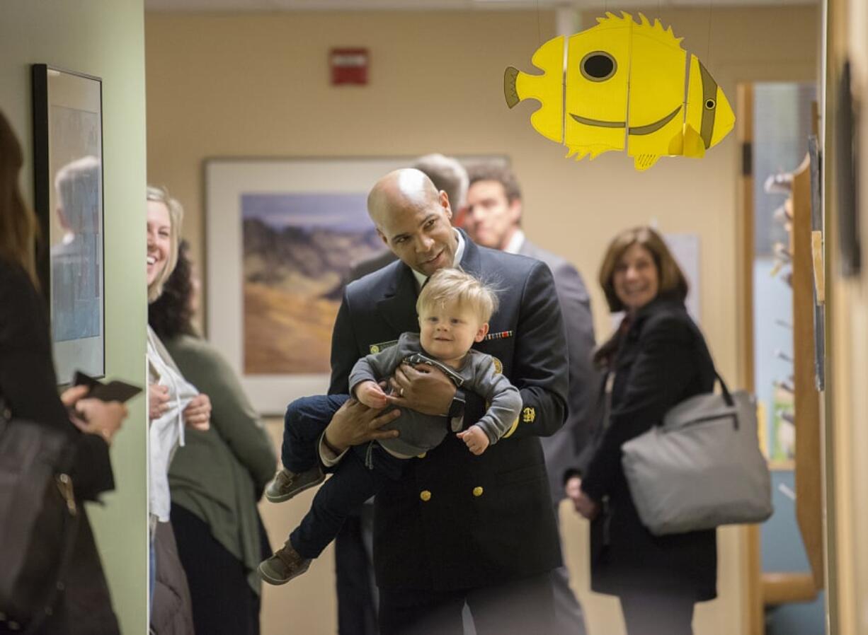 U.S. Surgeon General Dr. Jerome Adams plays with Everett Banse-Fay of Vancouver, 15 months, while walking through the hallway during a visit to Evergreen Pediatric Clinic on Northeast 87th Avenue in Vancouver. Adams toured the clinic during his trip to Vancouver as well as Clark County Public Health. He spoke with those involved in measles outbreak response efforts, and chatted with residents like Everett, who got his measles vaccine in January, and his mom, Cerisse Wilson, who was initially hesitant about vaccines before speaking with her son’s pediatrician.