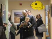 U.S. Surgeon General Dr. Jerome Adams plays with Everett Banse-Fay of Vancouver, 15 months, while walking through the hallway during a visit to Evergreen Pediatric Clinic on Northeast 87th Avenue in Vancouver. Adams toured the clinic during his trip to Vancouver as well as Clark County Public Health. He spoke with those involved in measles outbreak response efforts, and chatted with residents like Everett, who got his measles vaccine in January, and his mom, Cerisse Wilson, who was initially hesitant about vaccines before speaking with her son’s pediatrician.