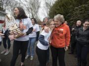 Washougal's Beyonce Bea, from left, celebrates the girls state basketball championship with teammate Kiara Cross and Washougal Mayor Molly Coston at Reflection Plaza in Washougal on Friday morning, March 8, 2019.