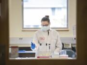 Forensic scientist Mariah Coffey works on a DNA sample at the Washington State Patrol Crime Lab on March 7. Coffey was hired to exclusively test rape kits.