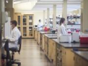 Forensic scientists work on DNA samples at the Washington State Patrol Crime Lab in Vancouver in 2019. The lab was instrumental in clearing the stat's backlog of sexual assault kits.