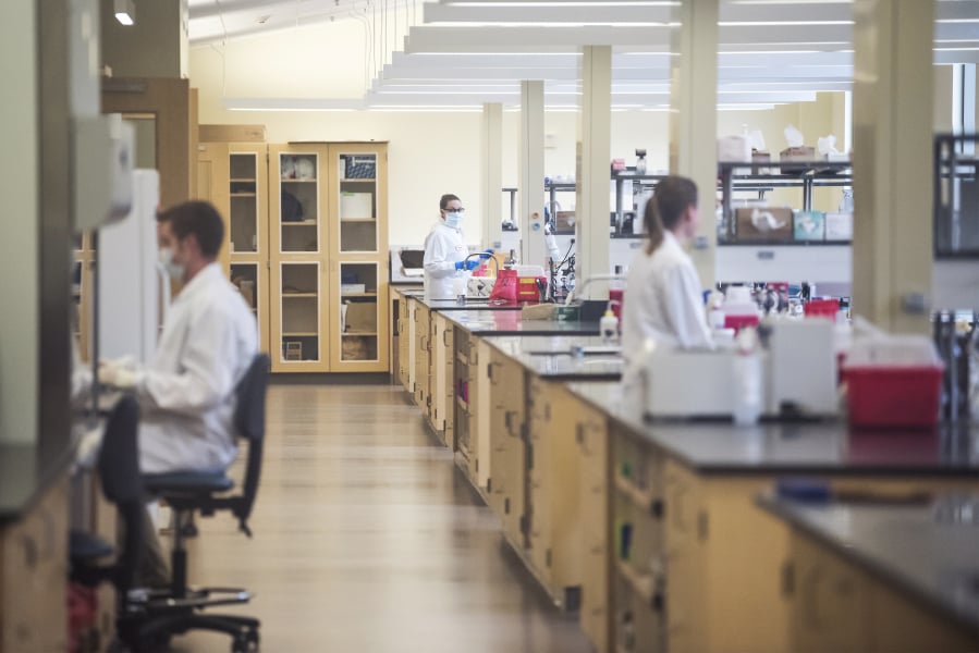 Forensic scientists work on DNA samples at the Washington State Patrol Crime Lab in Vancouver in 2019. The lab was instrumental in clearing the stat's backlog of sexual assault kits.