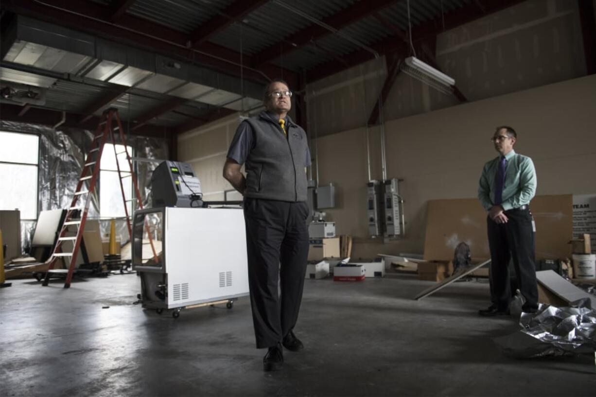 Laboratory Manager Bruce Siggins leads a tour of the Washington State Patrol Crime Lab in Vancouver. The unused space will house a high-throughput lab, which could cut the time it takes to analyze rape kits collected statewide.