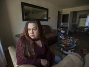 Claudia Franson gazes out of the window of her home in Hazel Dell while her son, Maximus Orellana, plays with a collection of toy cars. Franson is a stay-at-home mom for her nine children but will soon be entering the workforce. Legislators in Olympia are considering a bill intended to help families like hers.