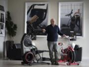 Interim Nautilus CEO M. Carl Johnson III joined the exercise equipment brand’s board in 2011. He’s standing next to the Bowflex Max Trainer M8, left, which is one of the machines that is linked to a product that may be essential to the company’s future success: the Max Intelligence digital platform. At right is a Schwinn Classic Cruiser stationary bicycle.