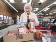 Christina Brown of Vancouver fills a box with groceries while checking out at the Vancouver Grocery Outlet. The store eliminated single-use plastic bags on March 1 and now offers boxes for customers who did not bring reusable bags. “I’m pretty glad,” Brown said.