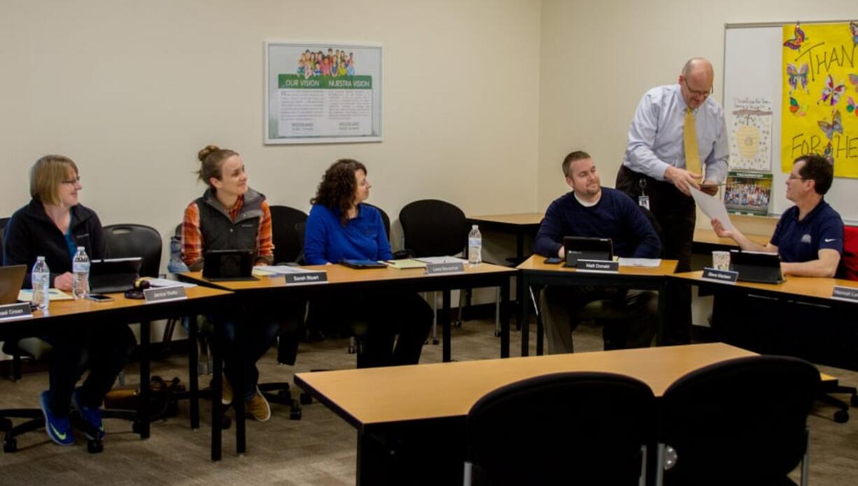 Woodland: Woodland Superintendent Michael Green, standing, presents each school board member with a certificate honoring their service. The board members are, from left, Janice Watts, Sarah Stuart, Lesa Beuscher, Matt Donald and Steve Madsen.