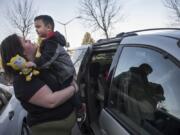 Katherine Shafer, a Clark College student studying addiction counseling, hoists her 3-year-old son Aiden out of the car on their way to Clark College’s on-campus child care center. Two of Shafer’s three sons are enrolled in the program while Shafer completes her degree. Clark College received nearly half a million dollars to pay for tuition and fees for families enrolled at the child care center.