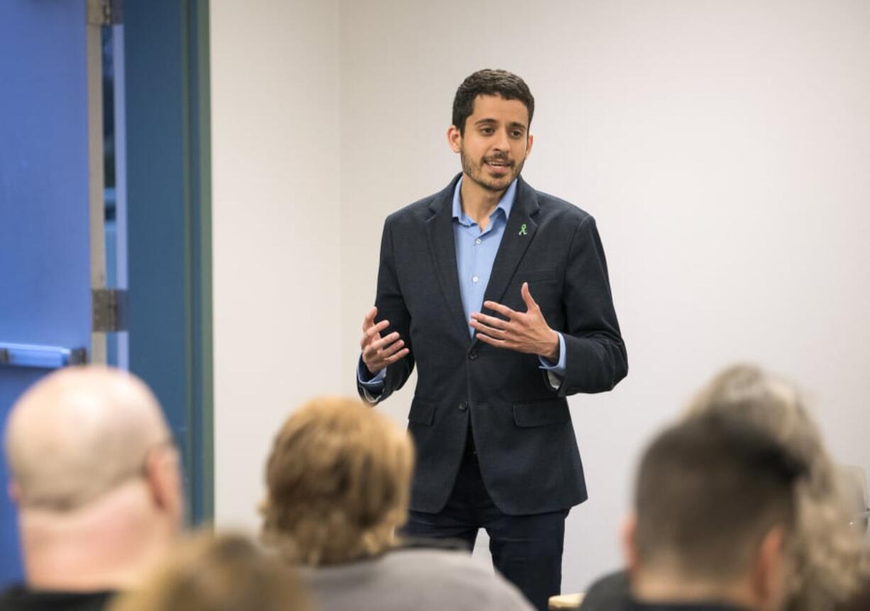 Adam Aguilera, a teacher at Heritage High School and secretary/treasurer for the Evergreen Education Association, announces his candidacy for Vancouver City Council Position 6 during the Vancouver Neighborhood Alliance meeting Wednesday night at Fisher’s Landing Fire Station 9 in Vancouver.