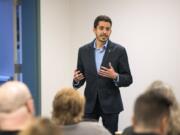 Adam Aguilera, a teacher at Heritage High School and secretary/treasurer for the Evergreen Education Association, announces his candidacy for Vancouver City Council Position 6 during the Vancouver Neighborhood Alliance meeting Wednesday night at Fisher’s Landing Fire Station 9 in Vancouver.