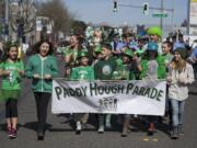 Students from Hough Elementary School greet spectators in Uptown Village while leading the annual Paddy Hough Parade on Friday afternoon, March 15, 2019.