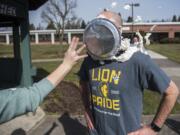 Scott McCallum, superintendent of the Washington State School for the Blind, takes a pie to the face as a reward for students who memorized 50 digits of Pi at the Washington State School for the Blind on Thursday afternoon, March 14, 2019.