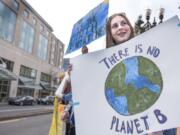 Maia Wolverton, 16, participates in a protest of inaction around climate change with other local teenagers near Esther Short Park on Friday afternoon. Teenagers around the world participated in a climate strike, including hundreds in Portland and Seattle. “You have to start somewhere,” Wolverton said.