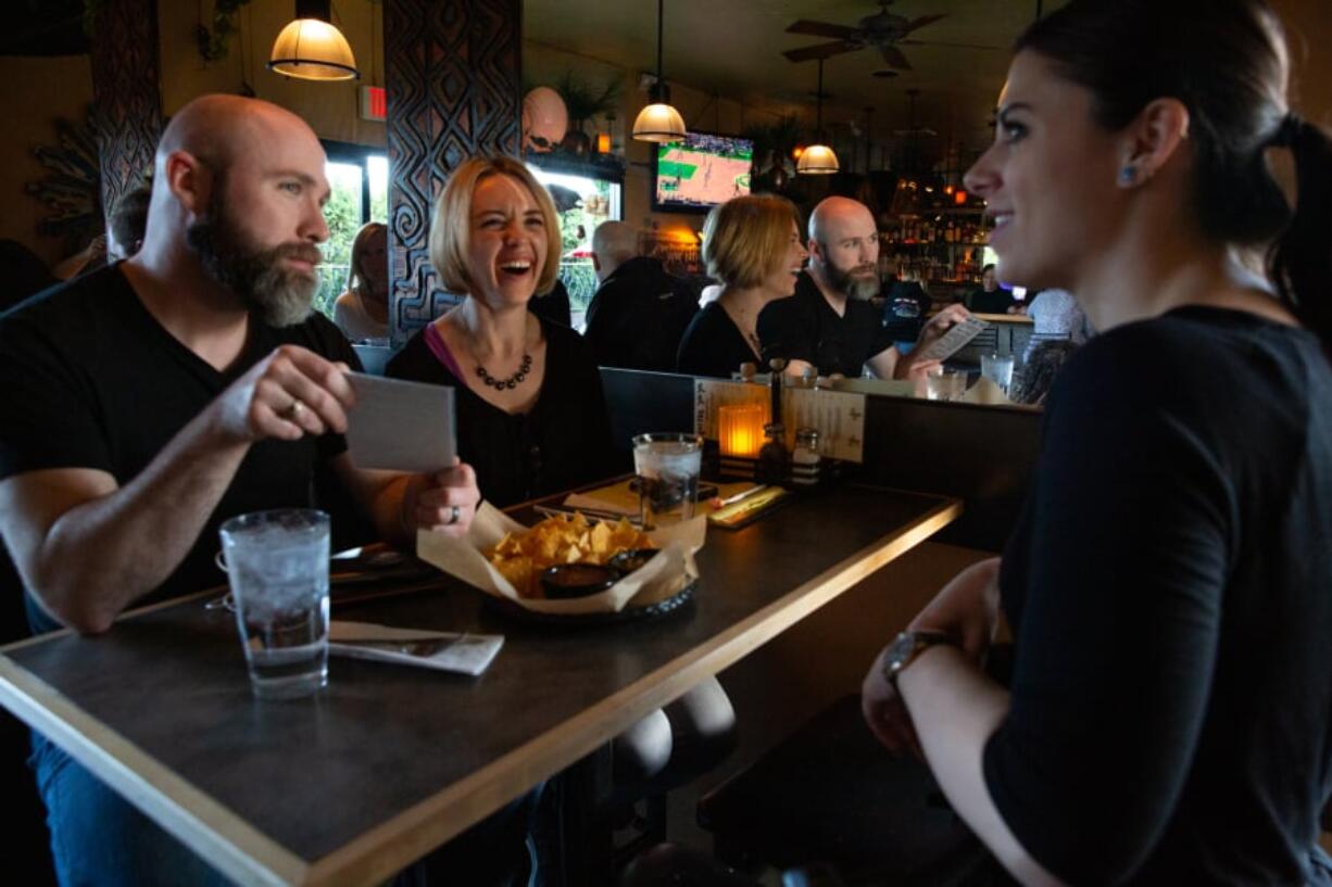 Ryan Green, from left, of Vancouver and Kayla Green order drinks from Brittany Stansberry at Cactus Ya Ya on a recent Sunday evening.