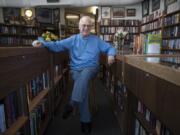 Owner Ron Pedersen sits inside the Hazel Dell Book Exchange. The store has been in operation for 44 years, and has survived retail headwinds by doubling as a vintage coin shop.