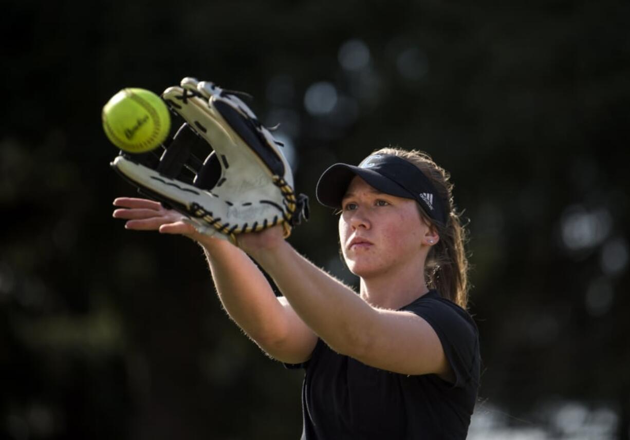 Mary Schorn runs through warm-up drills with her teammates during Clark College softball practice.