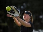 Mary Schorn runs through warm-up drills with her teammates during Clark College softball practice.