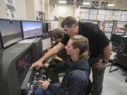 Junior Alex Reif, 17, from left, joins aviation technology instructor Robert Reinebach and Kevin Gamble, 17, also a junior, as they take to the sky in a flight simulator during class at Cascadia Tech Academy. Boeing’s Pilot Outlook for 2018 to 2037 estimates a large shortage of pilots -- 790,000 worldwide, so Reinebach hopes to prepare students for a robust future in the field. ‘All the major airlines are hiring like 500 pilots a year to 1,000 pilots a year,’ he said.