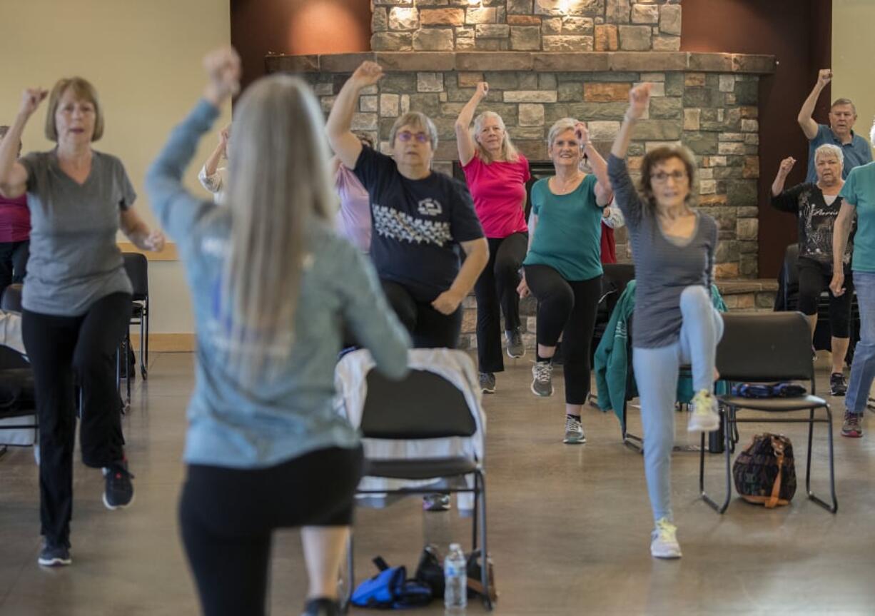 Participants in an EnhanceFitness class keep in step with instructor Laurie Porter while working out at Battle Ground Community Center. The class provides free group exercise for people 60 and older.