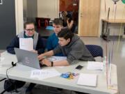 Felida: Skyview High School students, from left, Ella Konency, Ian Baldwin and Benecio Enriquez participate in a coding competition at George Fox University in Newberg, Ore.