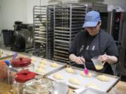 Deda’s Bakery co-owner Catherine Misener prepares croissants for baking. If she had to do over again, she says a $10,000 espresso machine would have been a good investment for the bakery.