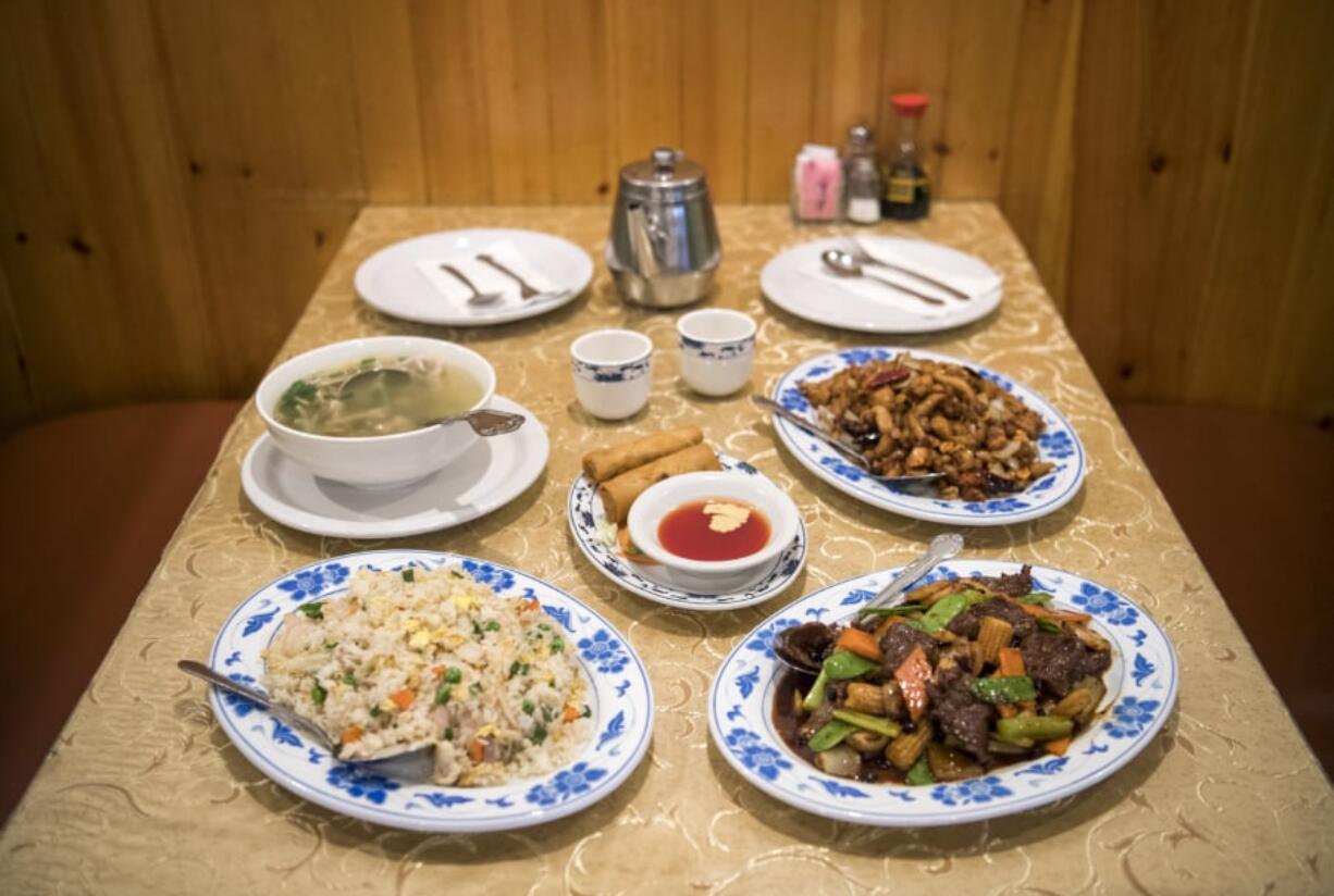 Among the offerings at Golden City in Vancouver are, clockwise from bottom left, combination fried rice, shredded pork and spicy cabbage soup, kung pao chicken, Golden City beef and crispy vegetarian rolls, center.