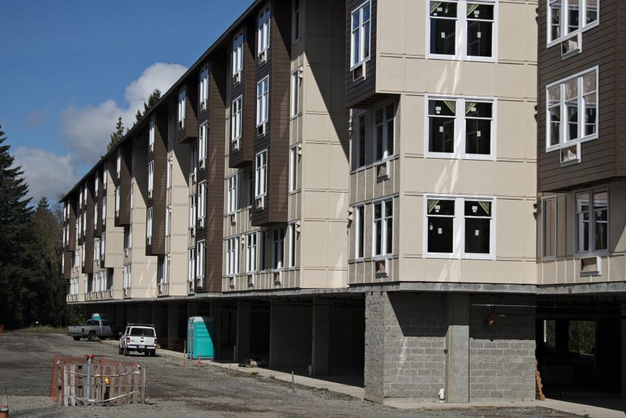 Vehicles are seen parked beneath the 134th Street Lofts, which has not completed construction, on Tuesday morning. The project’s developers recently applied for a renewed permit.