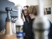 Hockinson High School paraeducator Angela Stanek, left, helps Natalie Zapata, 19, with a coffee order while working at the school’s coffee cart, which is run by the 18-21 transition program. Stanek is one of two paraeducators for the program, which has six students this year, and is expected to grow next school year.