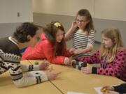 Washougal: Fort Vancouver Regional Library Washougal branch’s Rachael Ries, from left, with Columbia River Gorge Elementary School students, from left, Lauren Byrne, Aubrey Timmons and Bailey Wright in the school’s Coding Club, where students recently used robot blocks to learn about critical thinking.