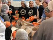 Clark County: Volunteers packing food at one of two Clark County events where volunteers worked in an assembly line to create more than 20,000 meals as part of a national effort sponsored by MOD Pizza and Generosity Feeds.