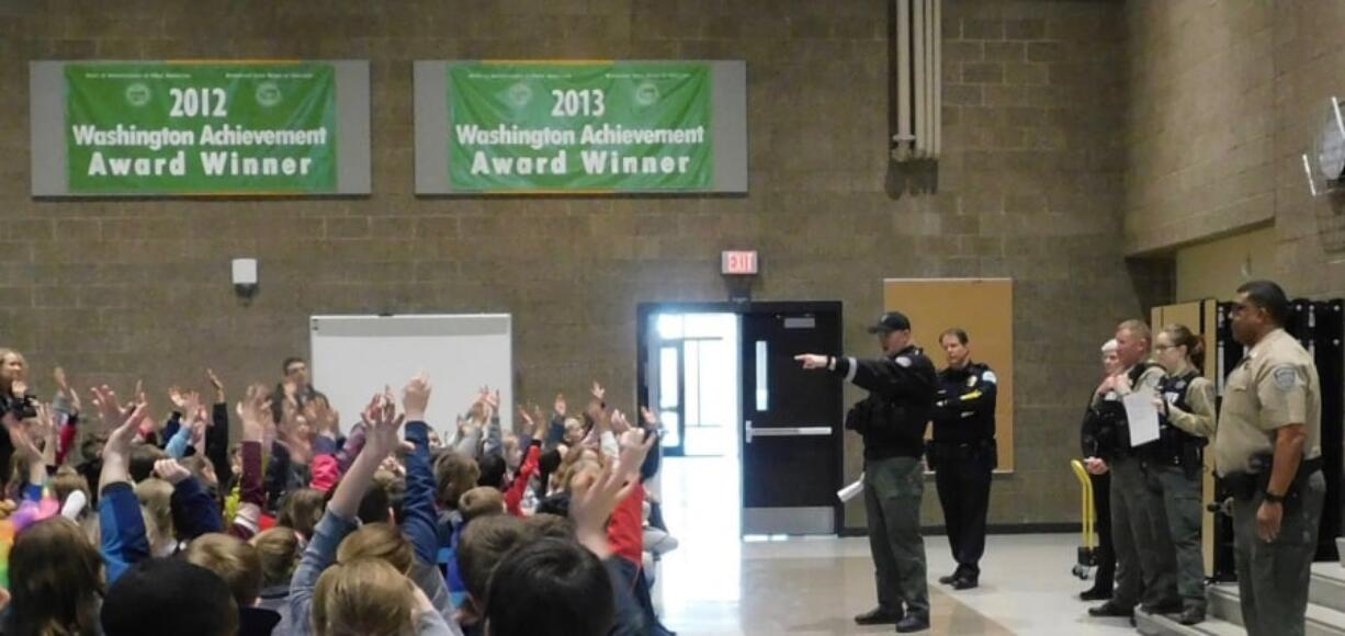 Ridgefield: An officer from the Clark County Sheriff’s Department answers questions during a visit to South Ridge Elementary School as part of the Police Activities League.