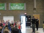 Ridgefield: An officer from the Clark County Sheriff’s Department answers questions during a visit to South Ridge Elementary School as part of the Police Activities League.