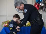 Clayton Jones, 4, is sworn in as an official police officer by Vancouver Police Chief James McElvain at the department’s east precinct late Friday afternoon. Clayton was diagnosed with terminal cancer in 2017 and has since developed a bond with the Vancouver Police Department.