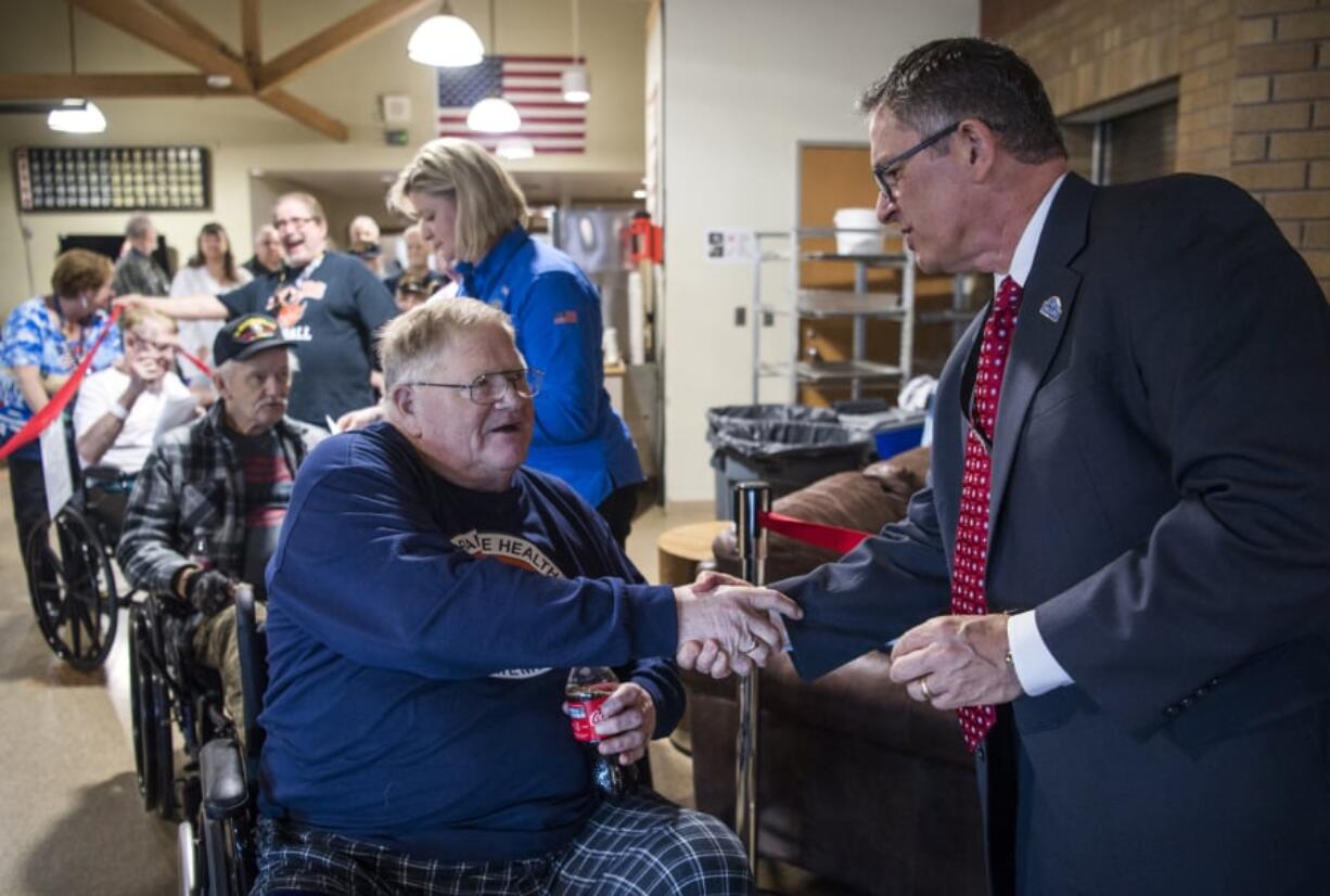 Vietnam veteran Erling B. Jenson shakes hands with Darwin Goodspeed, director of the VA Portland Health Care System, as Goodspeed hands out pins to honor veterans on Vietnam War Veterans Day at the Vancouver VA campus on Friday afternoon.