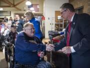 Vietnam veteran Erling B. Jenson shakes hands with Darwin Goodspeed, director of the VA Portland Health Care System, as Goodspeed hands out pins to honor veterans on Vietnam War Veterans Day at the Vancouver VA campus on Friday afternoon.