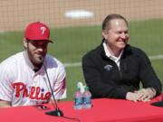 Bryce Harper, left, speaks during a news conference at the Philadelphia Phillies spring training baseball facility as his agent Scott Boras looks on, Saturday, March 2, 2019, in Clearwater, Fla. Harper and the Phillies agreed to a $330 million, 13-year contract, the largest deal in baseball history.