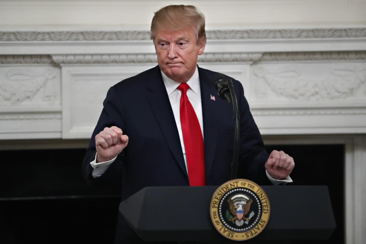 President Donald Trump gestures as he speaks to the National Association of Attorneys General, Monday, March 4, 2019, in the State Dining Room of the White House in Washington.