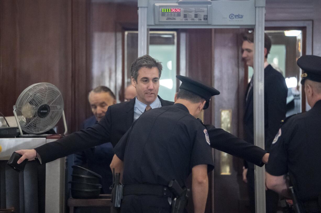 Michael Cohen, President Donald Trump's former lawyer, is screened by U.S. Capitol Police officers as he returns for a fourth day of testimony as Democrats pursue a flurry of investigations into Trump's White House, businesses and presidential campaign, at the Capitol in Washington, Wednesday, March 6, 2019. He appears today before the House Intelligence Committee. (AP Photo/J.