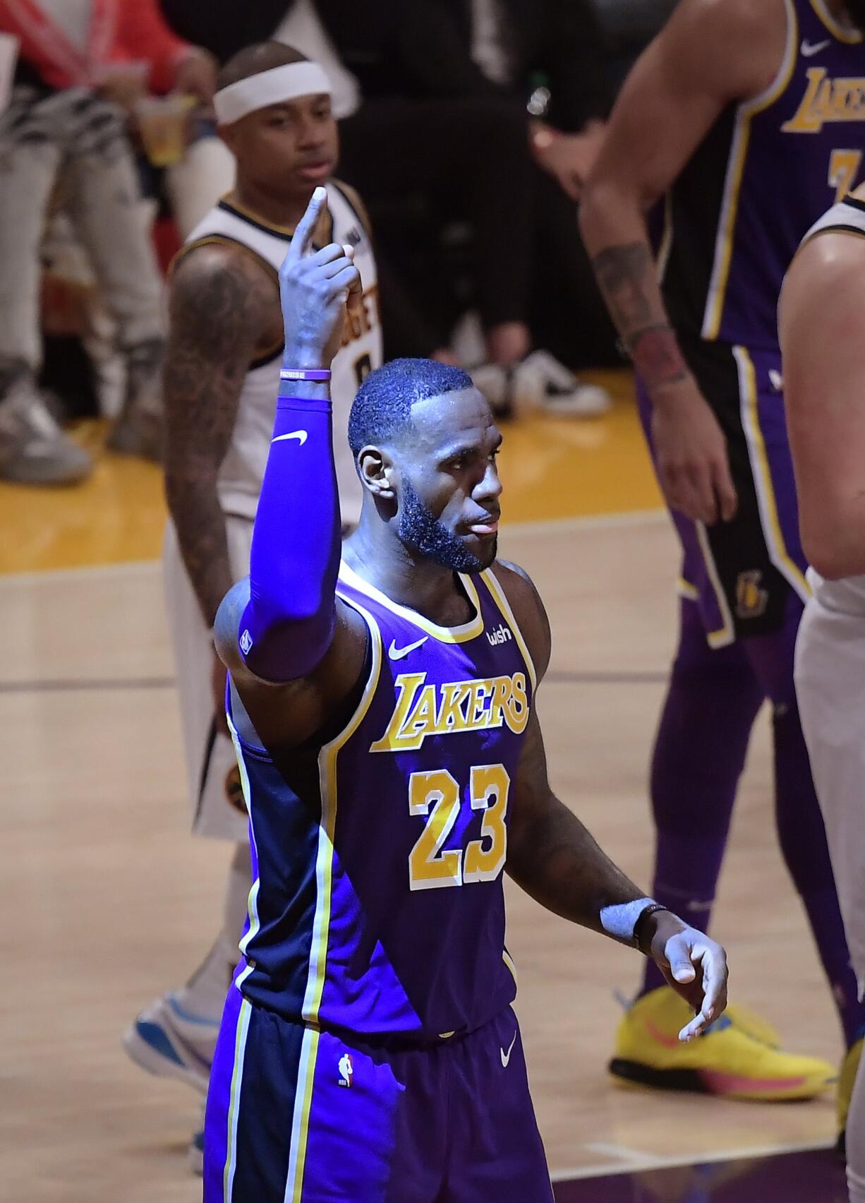 Los Angeles Lakers forward LeBron James gestures after scoring during the first half of the team's NBA basketball game against the Denver Nuggets on Wednesday, March 6, 2019, in Los Angeles. With the basket, James passed Michael Jordan for fourth place on the NBA's career scoring list. (AP Photo/Mark J.