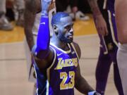 Los Angeles Lakers forward LeBron James gestures after scoring during the first half of the team's NBA basketball game against the Denver Nuggets on Wednesday, March 6, 2019, in Los Angeles. With the basket, James passed Michael Jordan for fourth place on the NBA's career scoring list. (AP Photo/Mark J.