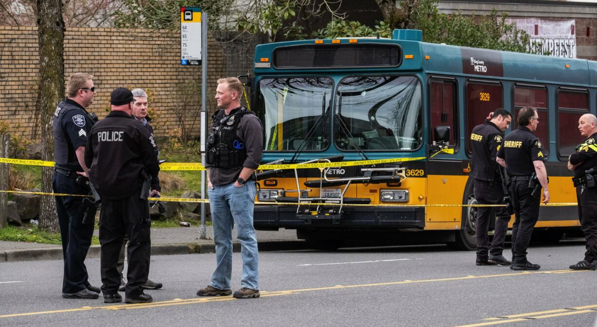 Several bullet holes can be seen in the driver's side window of a Metro Bus on Northeast 125th Street after a shooting in Seattle Wednesday, March 27, 2019.