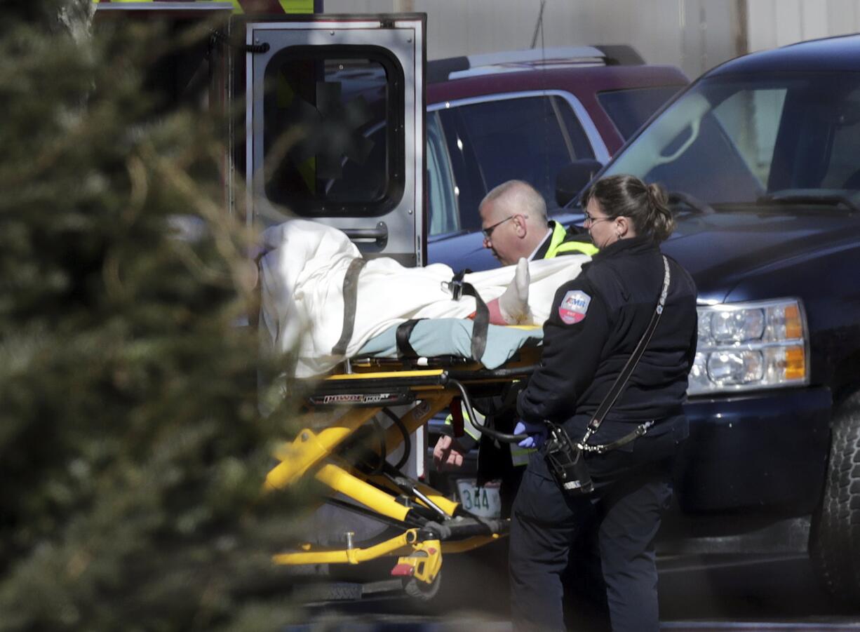 Emergency medical technicians carry a person on a stretcher into an ambulance outside the Quality Inn on Thursday, March 28, 2019, in Manchester, N.H. Two people had barricaded themselves in a first-floor room after one man was shot and killed there Wednesday night by police after he engaged Drug Enforcement Administration agents and police.