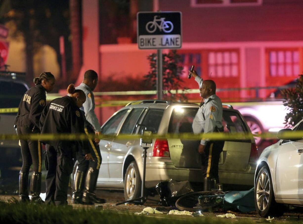 New Orleans Police examine damaged cars and bicycles on Esplanade Avenue in New Orleans after a car struck multiple people, killing several and injuring others following the Endymion Mardi Gras parade on Saturday, March 2, 2019.