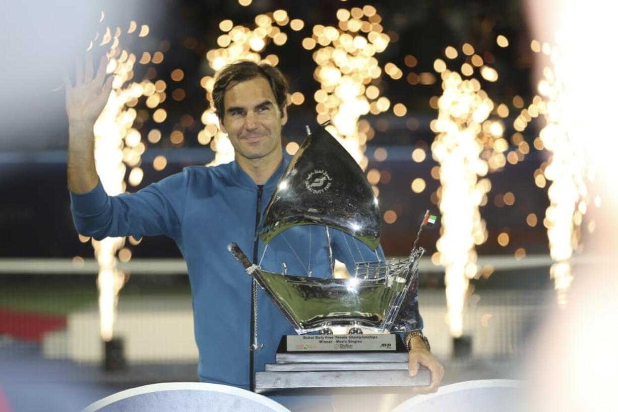 Roger Federer of Switzerland holds his trophy after winning the final match at the Dubai Duty Free Tennis Championship against Stefanos Tsitsipas of Greece during, in Dubai, United Arab Emirates, Saturday, March 2, 2019.