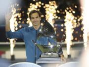 Roger Federer of Switzerland holds his trophy after winning the final match at the Dubai Duty Free Tennis Championship against Stefanos Tsitsipas of Greece during, in Dubai, United Arab Emirates, Saturday, March 2, 2019.