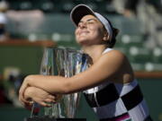 Bianca Andreescu, of Canada, smiles as she hugs her trophy after defeating Angelique Kerber, of Germany, in the women’s final at the BNP Paribas Open tennis tournament Sunday, March 17, 2019, in Indian Wells, Calif. Andreescu won 6-4, 3-6, 6-4. (AP Photo/Mark J.