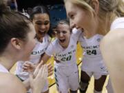 Oregon’s Satou Sabally, second from left, Sabrina Ionescu (20), Ruthy Hebard (24) and others celebrate after defeating UCLA in overtime in an NCAA college basketball game in the semifinals of the Pac-12 women’s tournament Saturday, March 9, 2019, in Las Vegas.