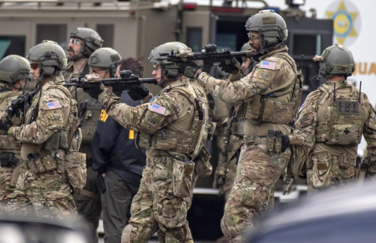 The FBI searches the home of Stephen Beal in Long Beach, Calif., Sunday, March 3, 2019, after taking him into custody in connection with a 2018 bombing at an Aliso Viejo beauty salon that killed his former girlfriend.