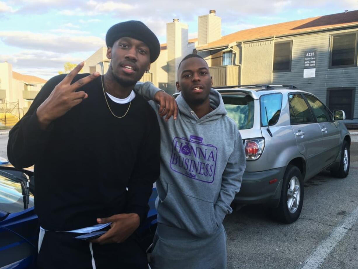 In this Dec. 27, 2018, photo, video blogger Shawn Cotton, left, poses for a portrait with rapper Wayne Walker, who performs under the stage name 30 Rich, after Cotton interviewed Walker for his YouTube channel “Say Cheese TV,” in Fort Worth, Texas. The killing of Zack Stoner, a pioneer in a new genre of news in which videographers interview street gangs and rappers in high-crime areas, has unnerved other gangland reporters nationwide, including Cotton. (AP Photo/John L.